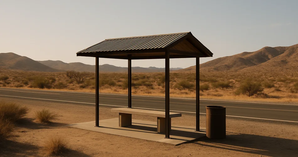 A shaded roadside resting area sits beside a highway in Baja’s dry desert landscape.